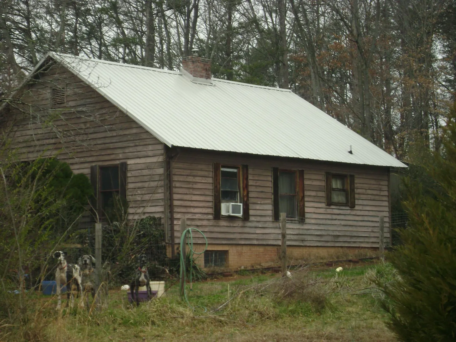 White metal roof on an old wood sided farmhouse, from a Metal Roof Installation job in Giltner